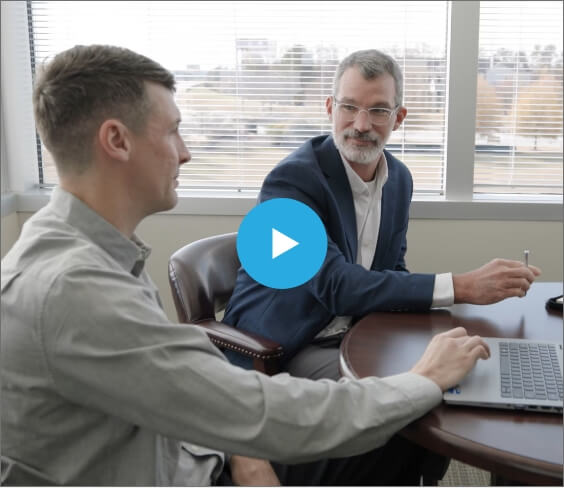 Brett Sitting at Desk During Interview